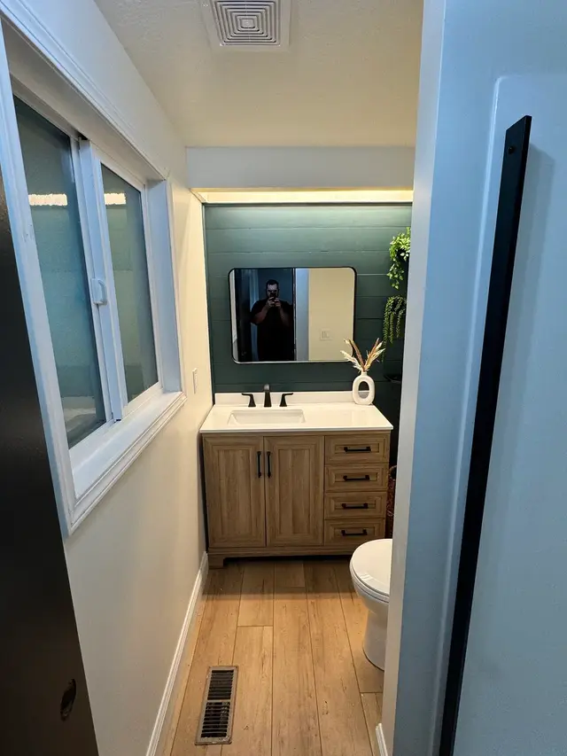 Bathroom remodel with green shiplap accent wall and oak vanity in North Bend OR – Premier Coastal Construction
