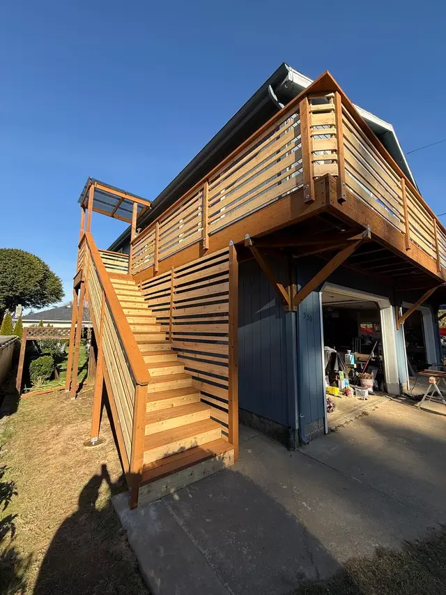 Elevated two-story deck with horizontal slat railing and staircase in North Bend OR – Premier Coastal Construction