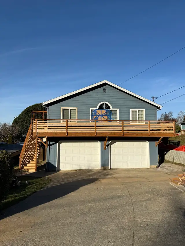 Second-story deck addition with horizontal railing over garage in Coos Bay OR – Premier Coastal Construction