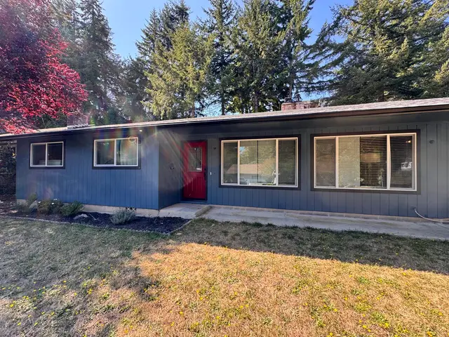 Home exterior renovation with new siding and red accent door in North Bend OR – Premier Coastal Construction